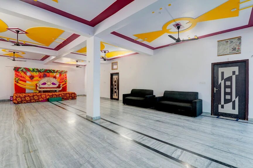 AC guest room with bed and seating at Sharda Lawn